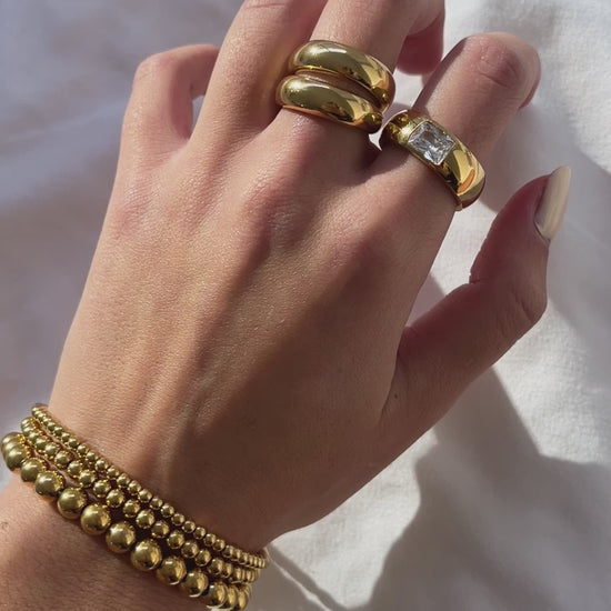 gold jewelry on hand, gold dome rings, gold beaded bracelets, gold crystal band ring