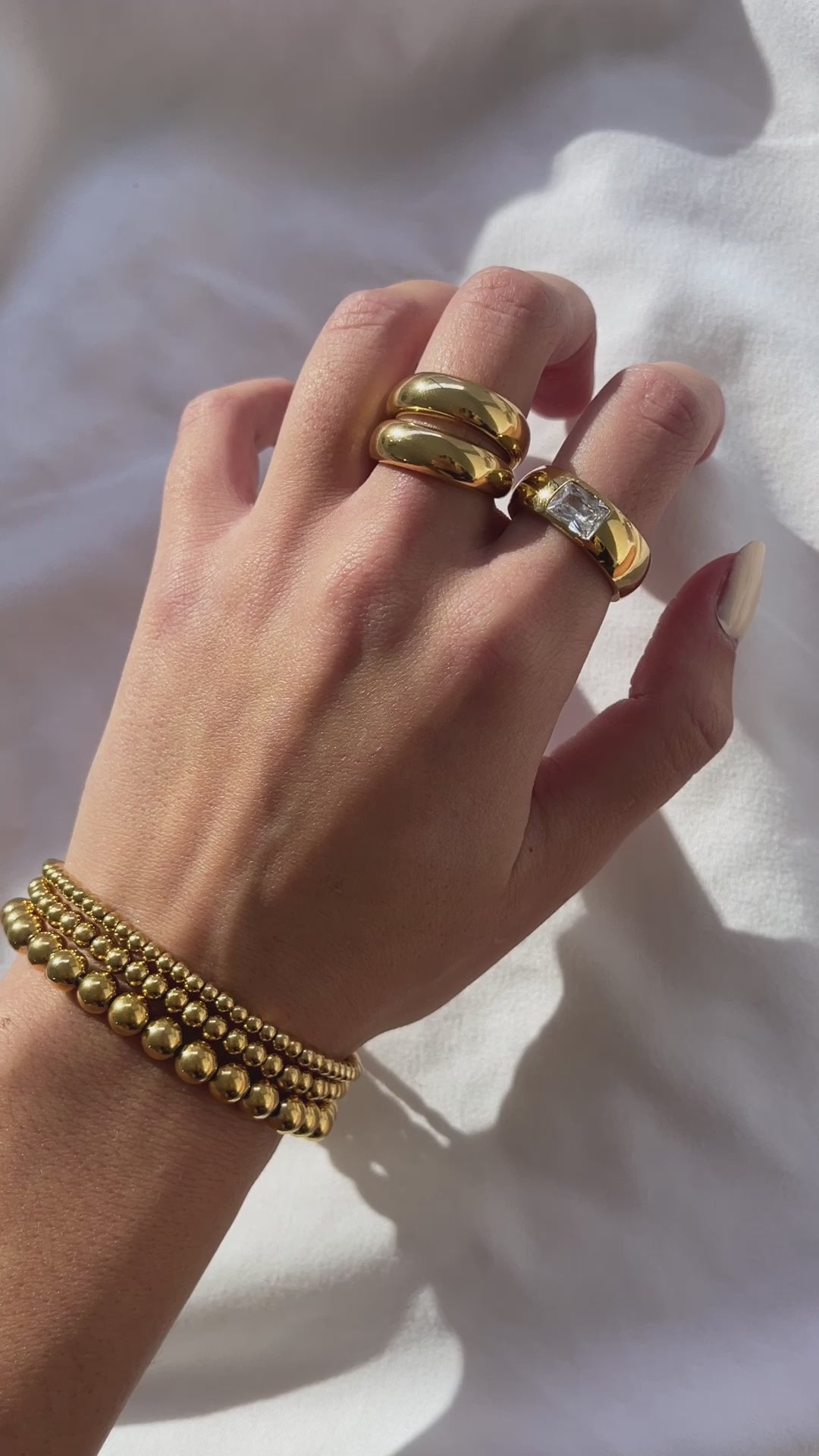 gold jewelry on hand, gold dome rings, gold beaded bracelets, gold crystal band ring