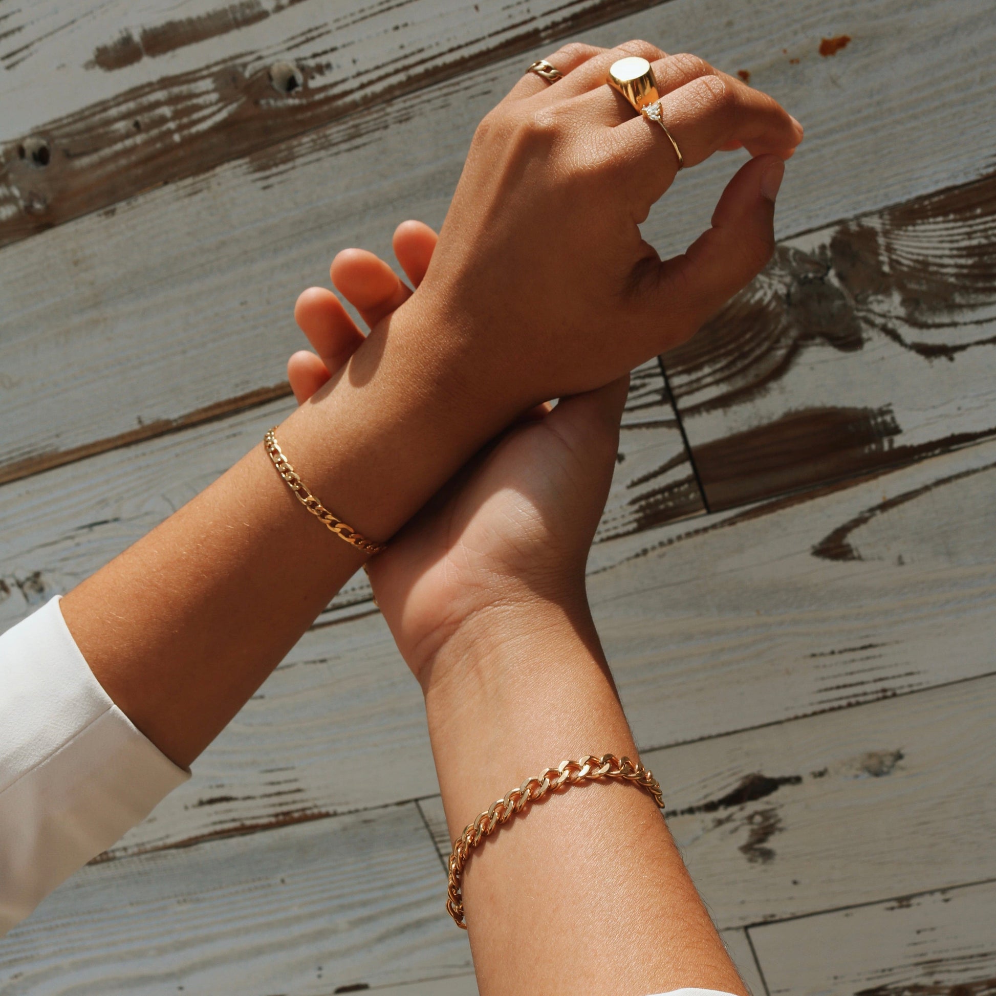 Alexia Crystal Ring and other gold jewelry on hands