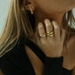 gold crystal band ring on model wearing gold jewelry