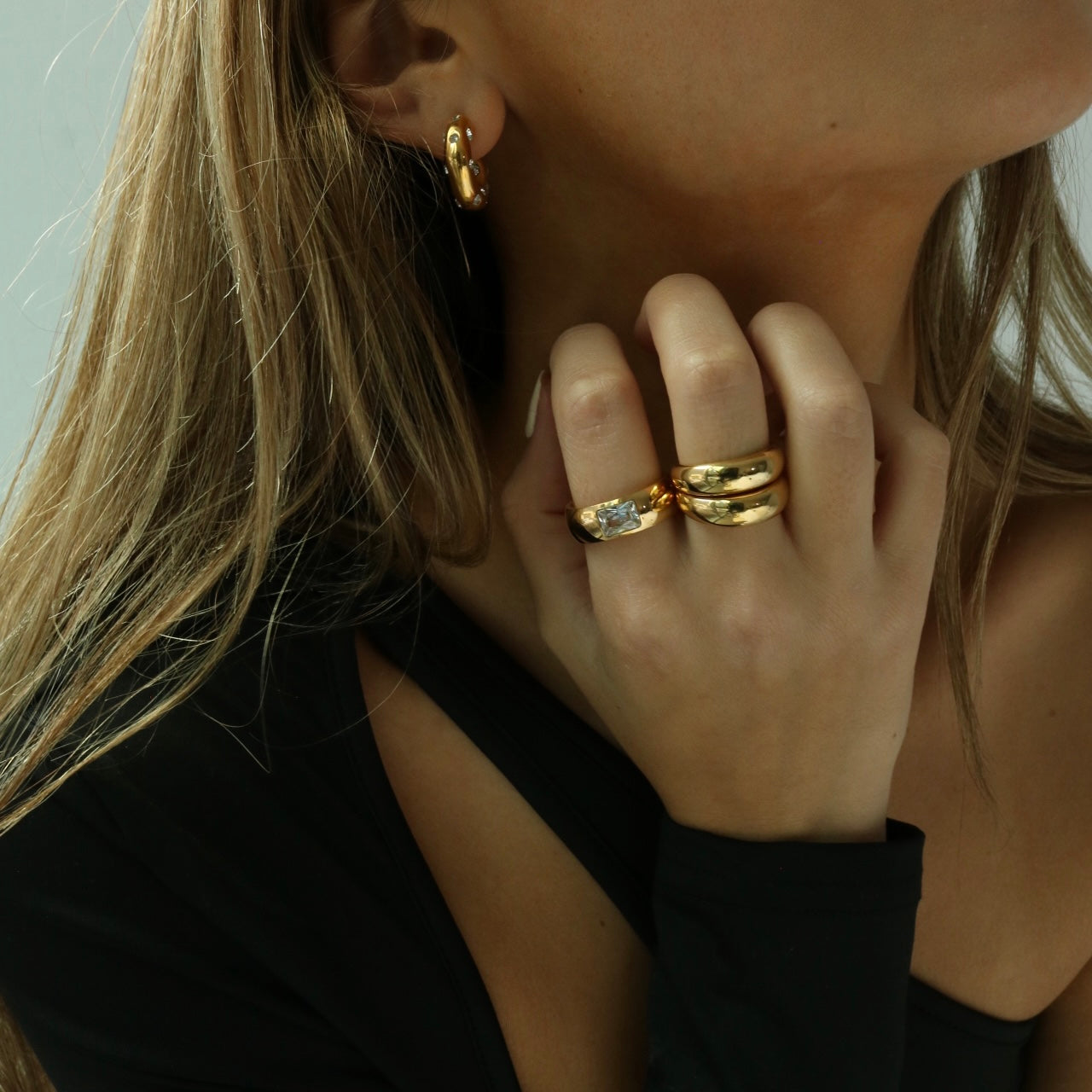 gold crystal band ring on model wearing gold jewelry