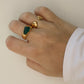 green stone agate ring on hand