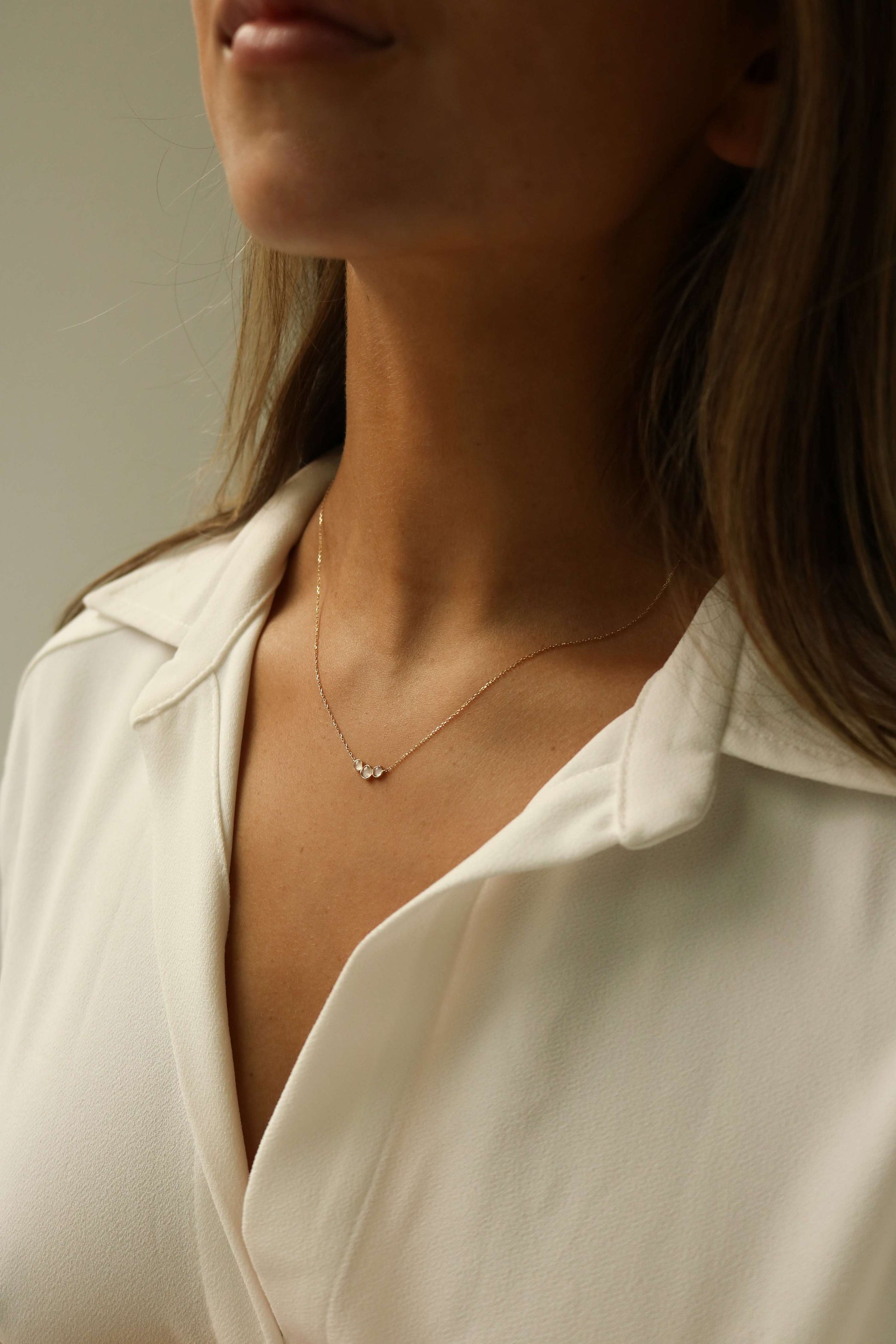 three stone moonstone pendant made of 14k solid gold with a dainty minimal chain