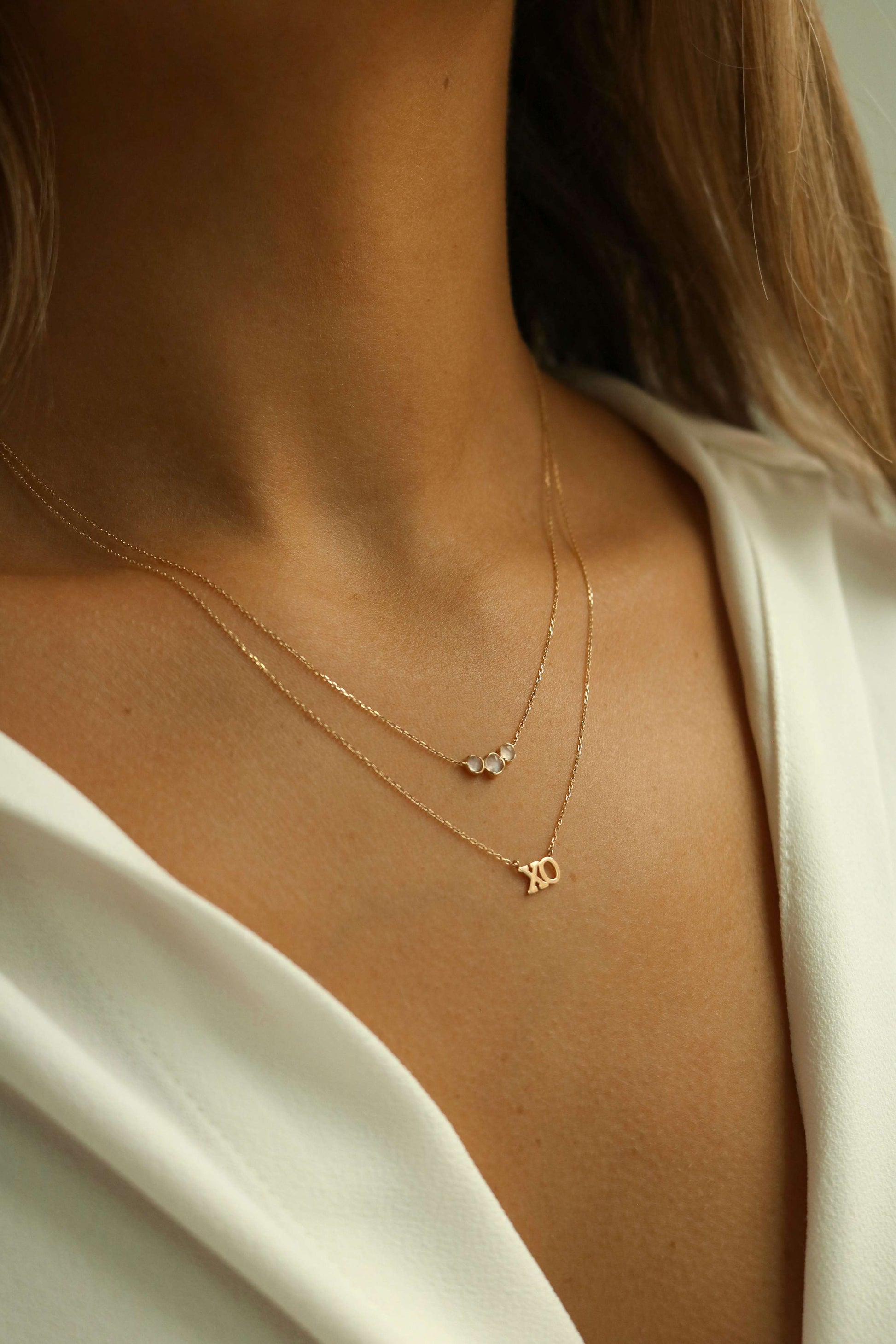 layered moonstone necklace and XO gold necklace